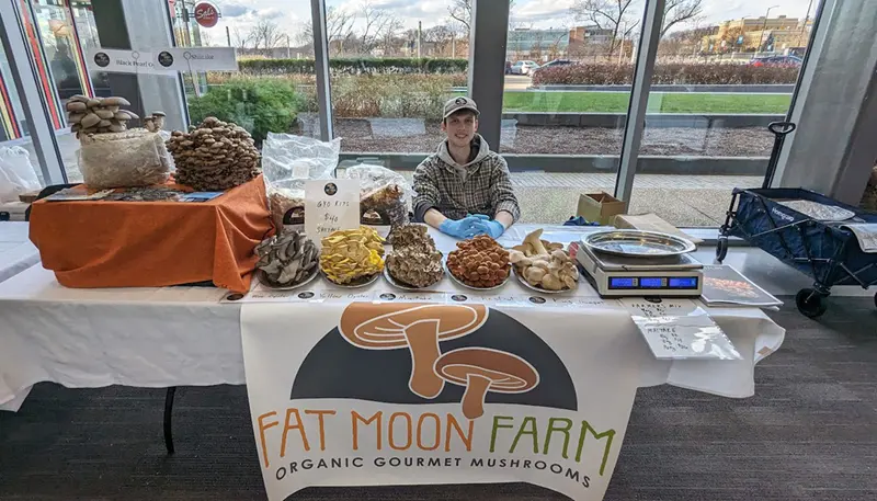 Owen Hunter selling mushrooms at the Rist Institute Indoor Farmer's Market at University Crossing.