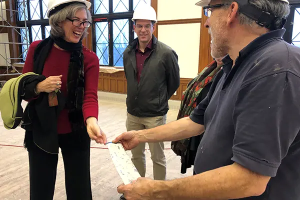 Pocobene shows duct taped that was used to strip off the covering paint to Assoc. Prof. Marie Frank and university planner Adam Baacke.