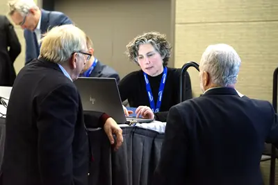 Group of people surrounding computer