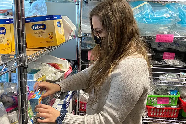 UMass Lowell MPH student Gina Bangrazi organizes supplies at Global Smile Foundation