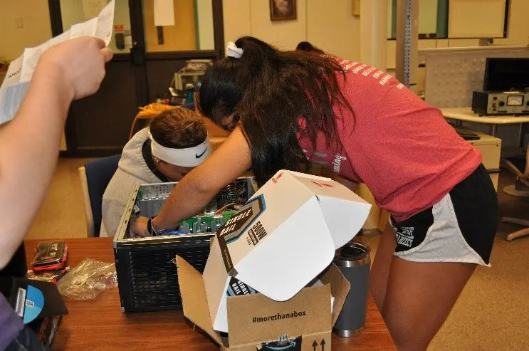 Two young women work on a project