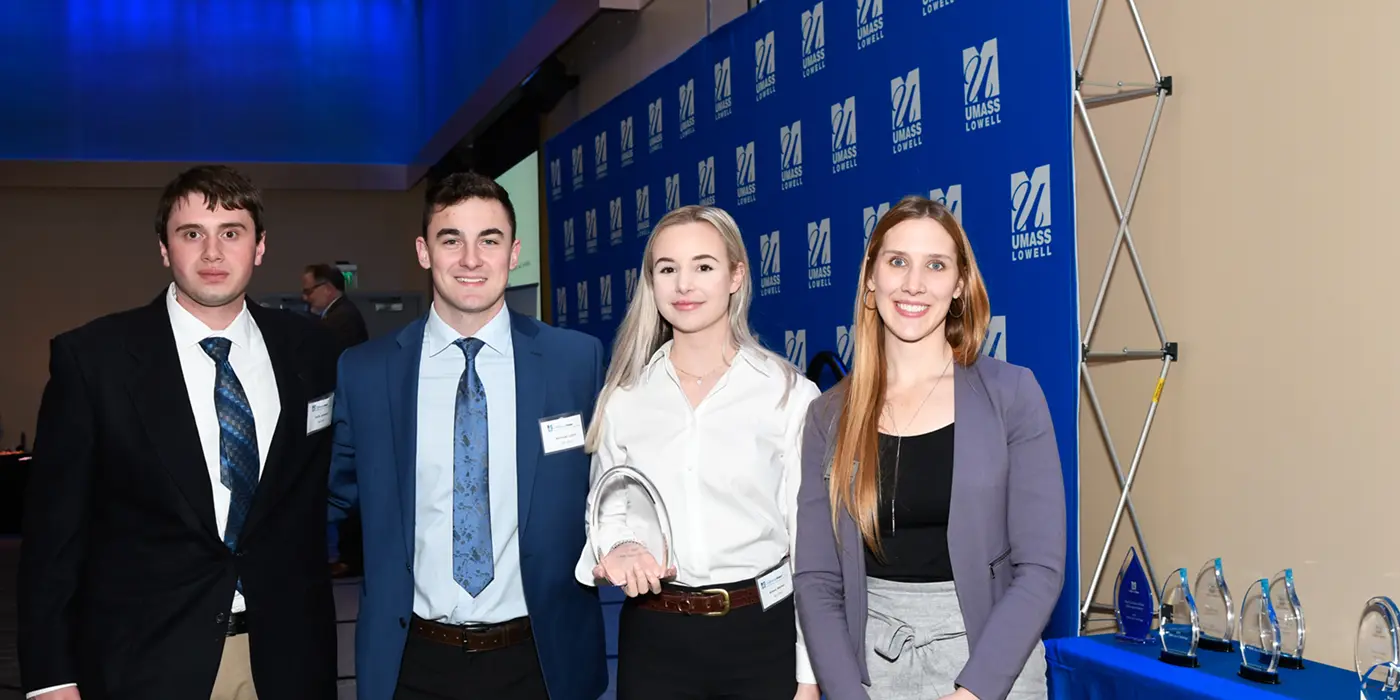RE-VIVE team members Derek Jamieson, Nicholas Lydon and Alison Michell pose with their Honorable Mention award and Holly Butler