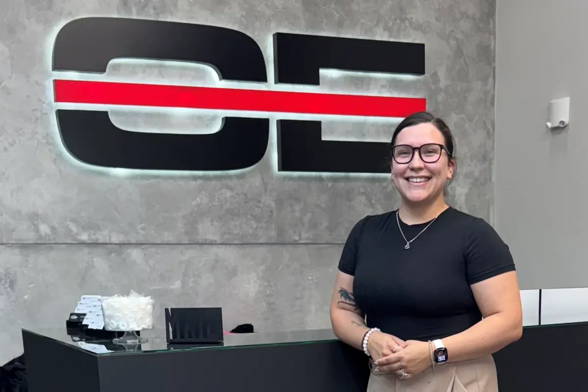 Rebecca Waupoose stands at the front desk at Optiline Enterprises.