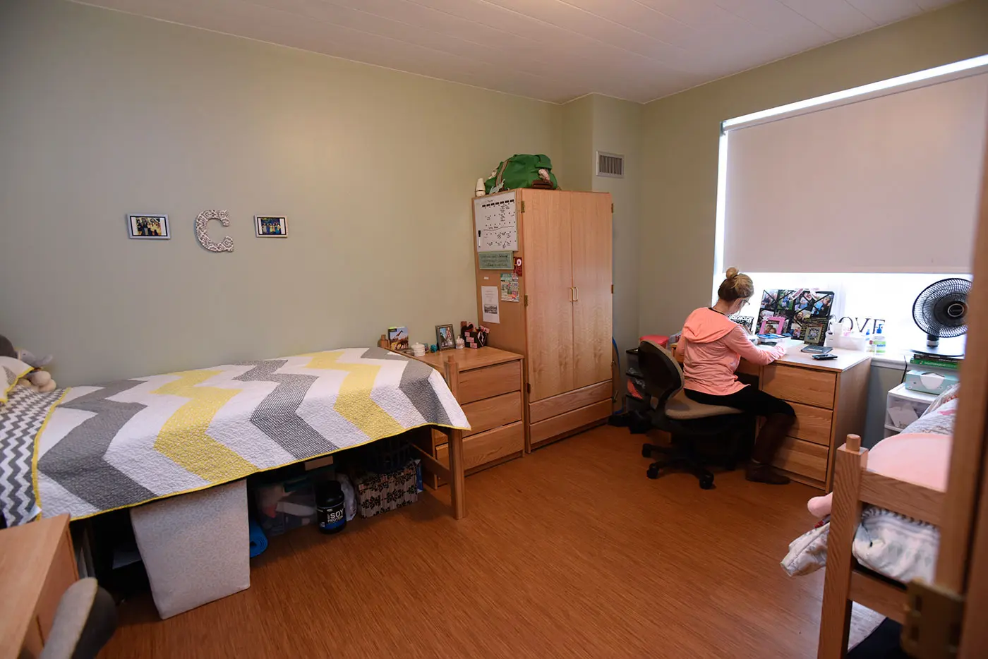 Riverview-Suites-interior-female-at-desk backside view 