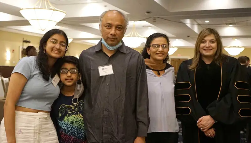 Rupal Trivedi poses with her family at UMass Lowell commencement