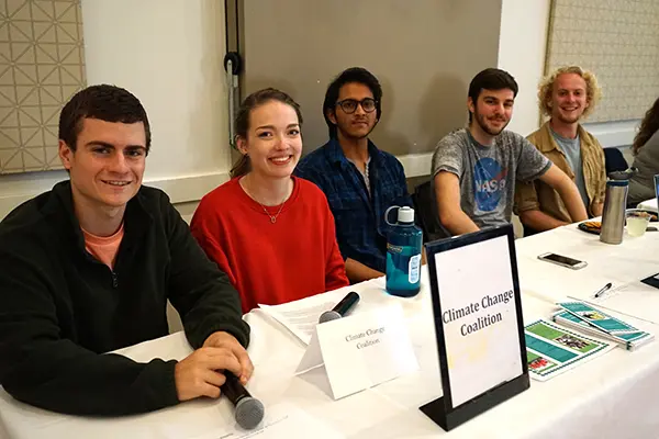 Climate Change Coalition members sit at a table at the Climate Change Teach-In