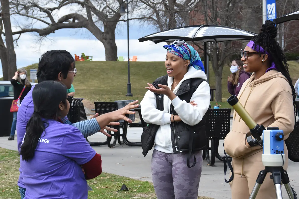 Grad students Sayantan and Ananya showing the solar telescope to visitors