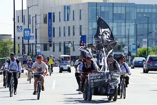 A pirate-themed bicycle-powered vehicle crosses a bridge