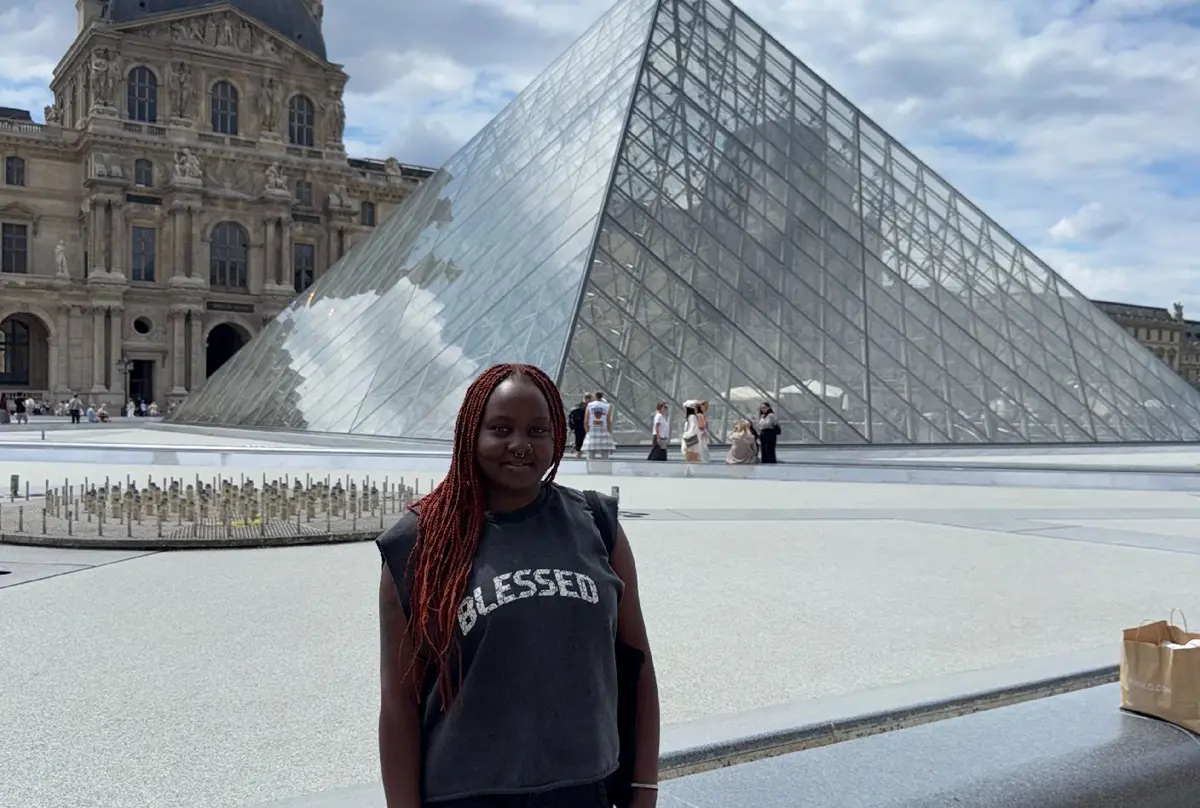 Serah Njoroge stands outside the Louvre Museum in Paris, France.