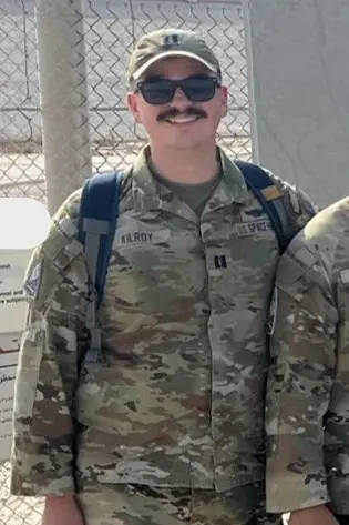 Shawn Kilroy stands dressed in military attire.