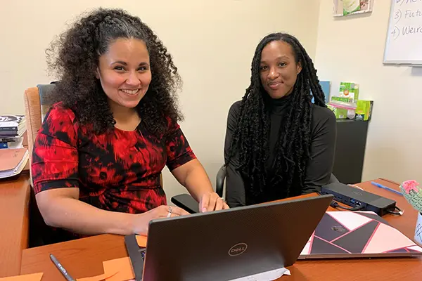 UML Sociology Asst. Prof. Chandra Waring and senior sociology major Kimani Brown look at research together