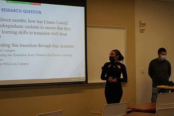 UMass Lowell sociology majors Sokharath Koy and Tyler Billy present the results of their student survey