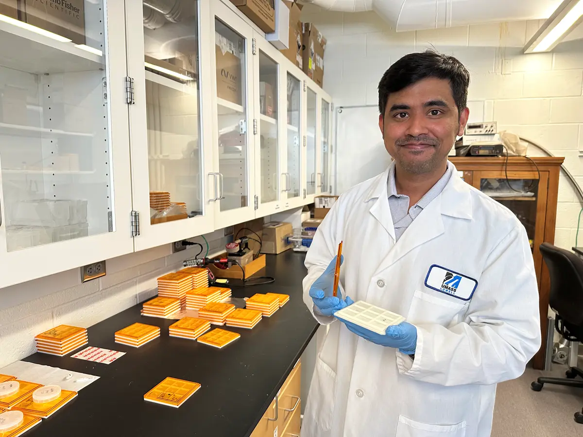 Asst. Engineering Prof. Anhar Bhuiyan holds up a tray of gallium oxide samples