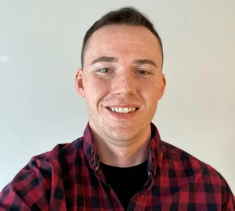 Chris Sain, Alumni of the radiological sciences program, headshot wearing a red flannel shirt