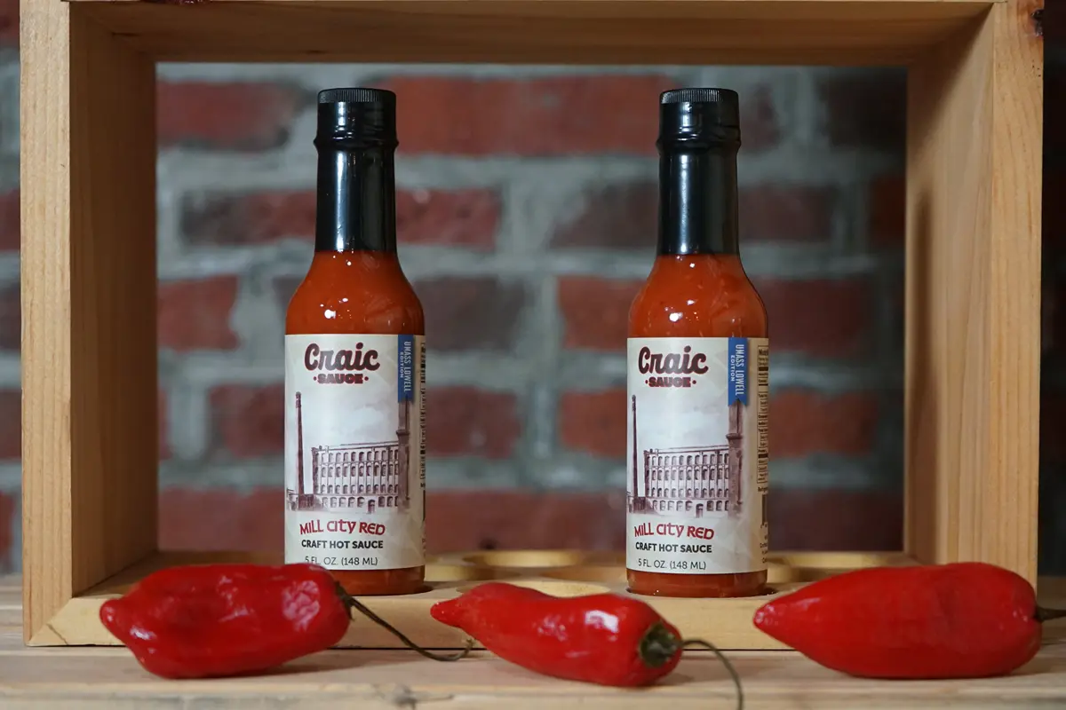 Bottles of Mill City Red, UMass Lowell branded Craic sauce
