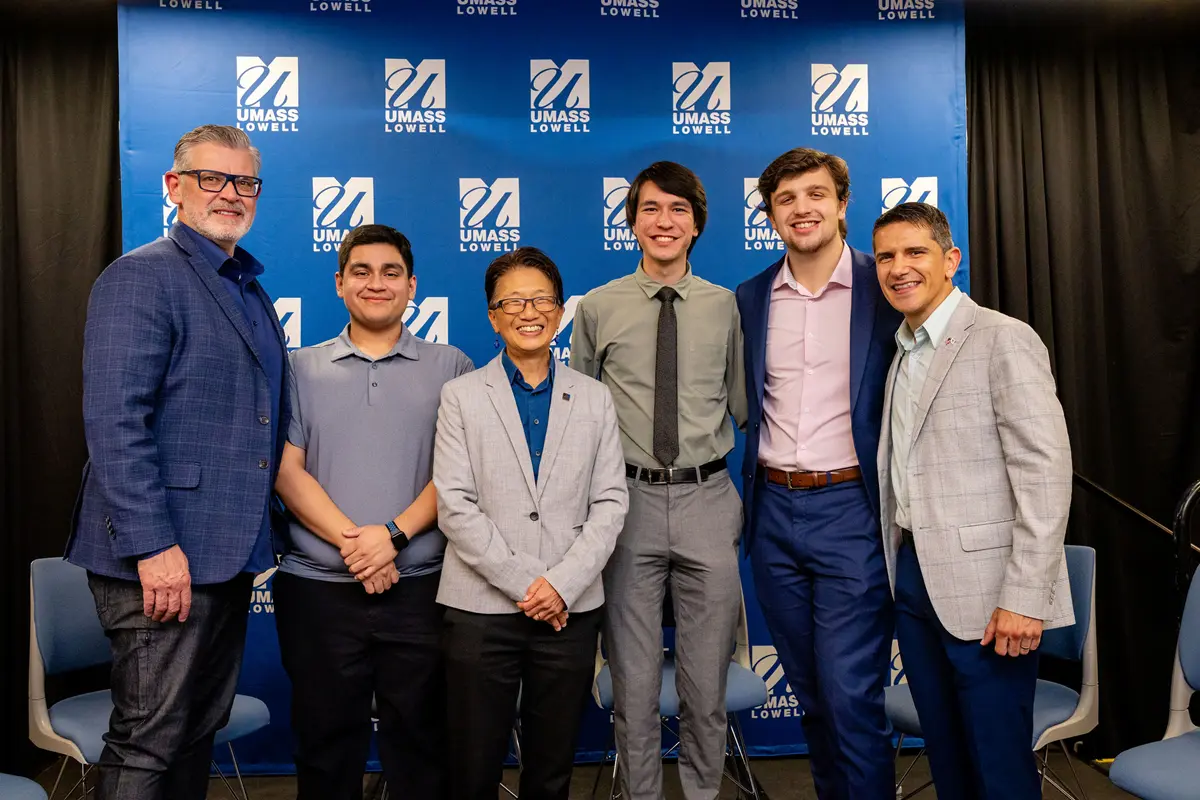 Six people stand on a stage at the Celebration of Industry Partnerships event.
