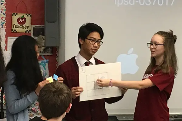 UML computer science major and UTeach minor Anthony Rom presents a lesson to middle-school students
