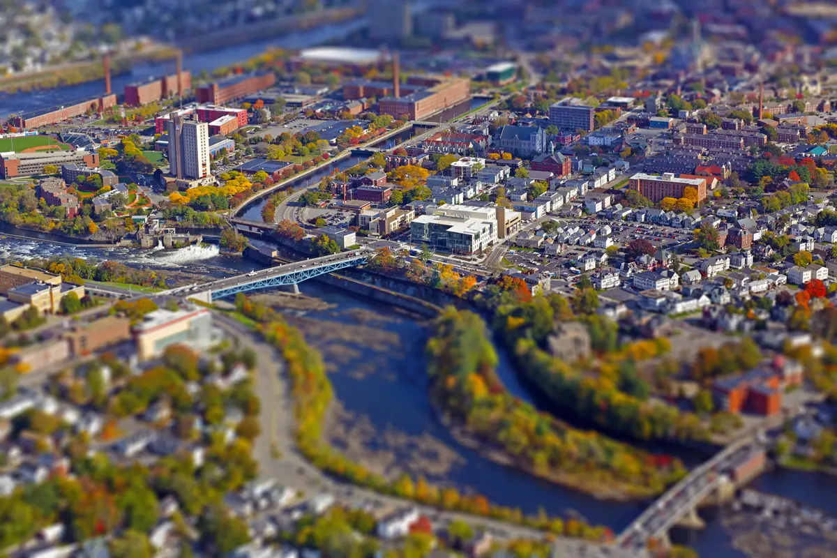 An aerial view of a college campus alongside a river.