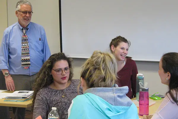 Prof. Robert Forrant with looks on as students discuss what makes up an ideal city