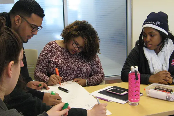 Nairoby Gabriel, center, and other students discuss the characteristics of an ideal city