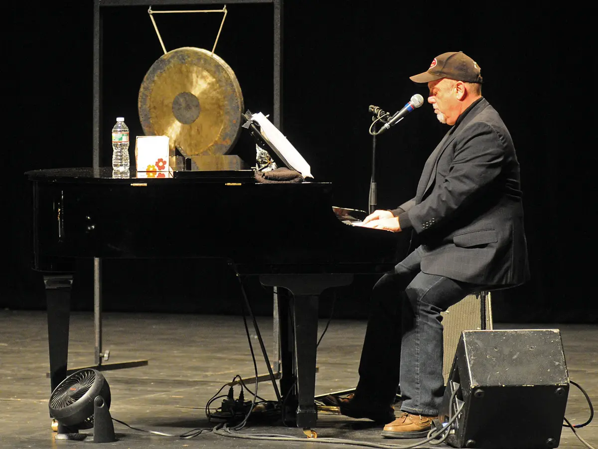 Billy Joel performing on stage at UMass Lowell