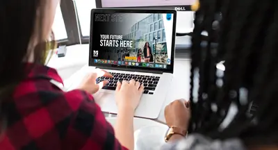 two students viewing umass lowell's digital viewbook on a laptop