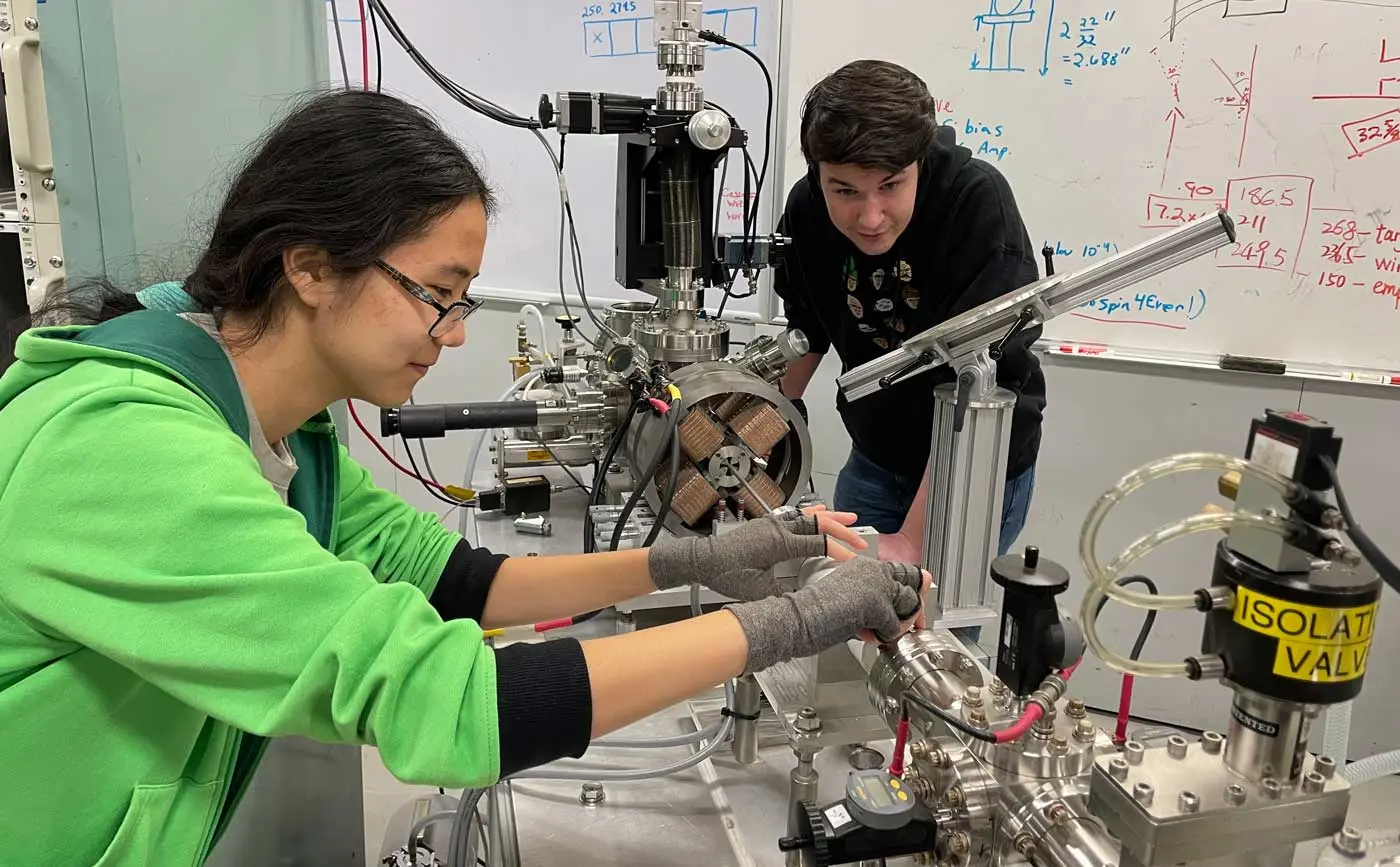 Two students work with equipment in a UMass Lowell lab