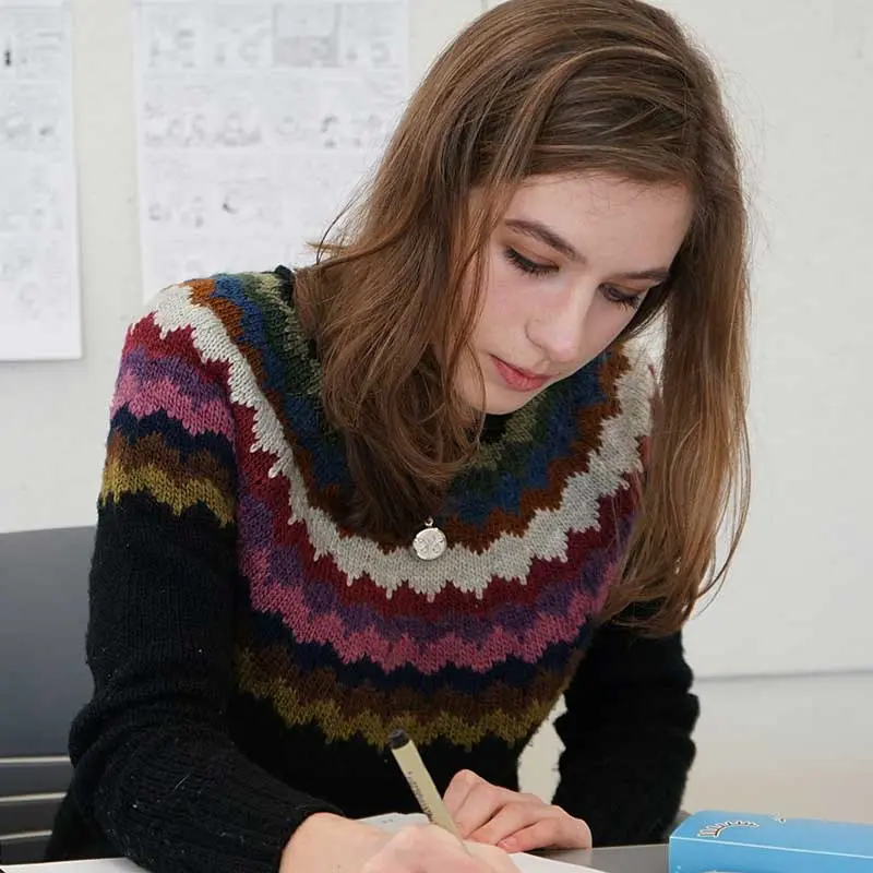 Emmy Misail works on her comic strip