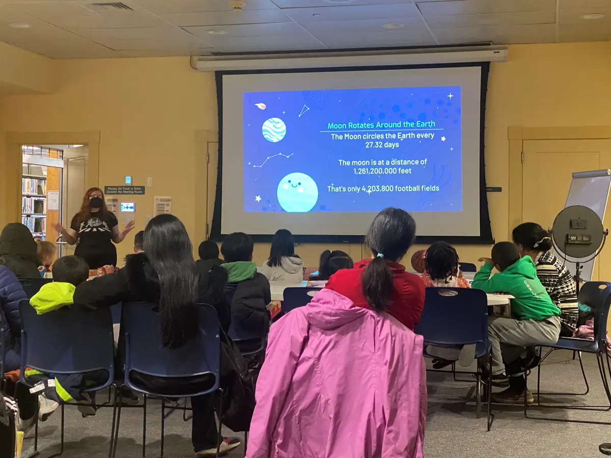 Julie Sage interacting with children and the families at Burlington Public Library.