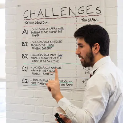 man in front of white board