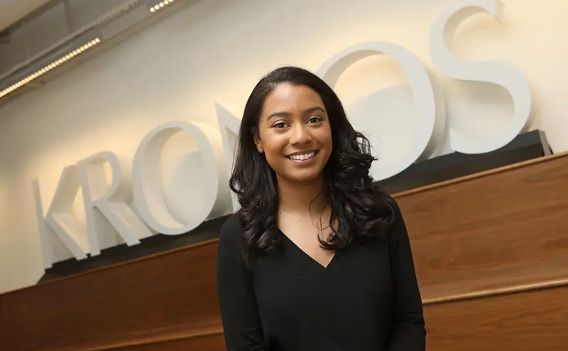 Maylis Brito stands in front of a Kronos sign
