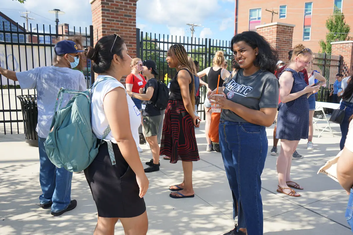 Students outside talking and milling about