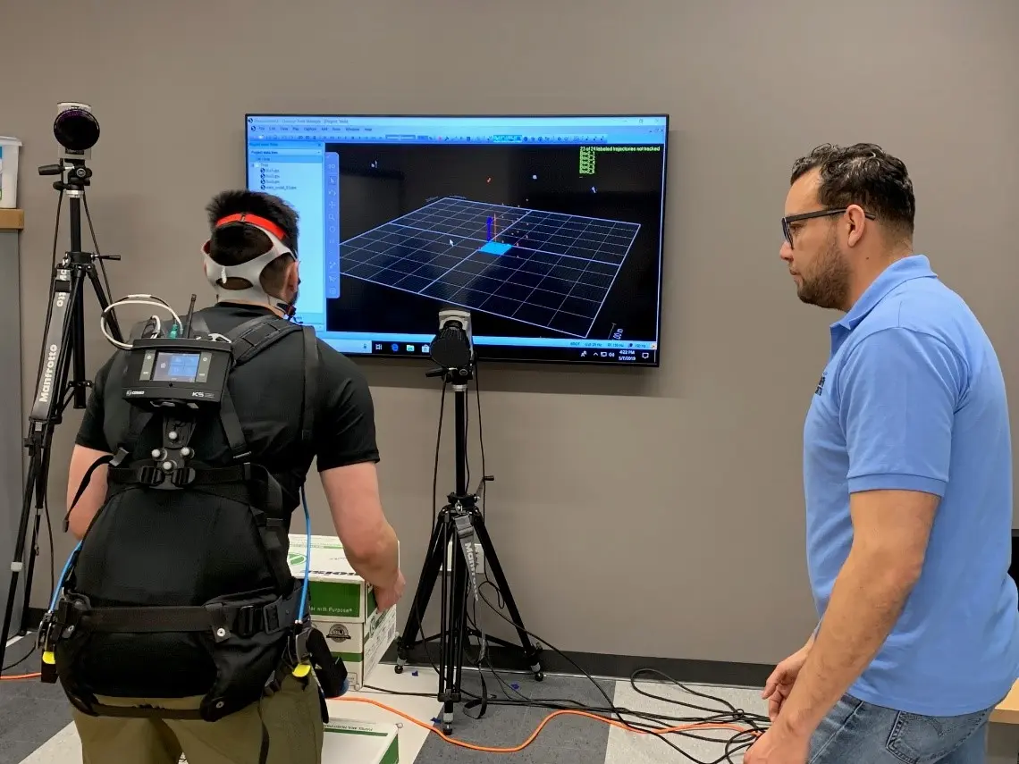 BME student, Anthony Vo, and Graduate student, Jose Pacheco, testing the exoskeleton suit.