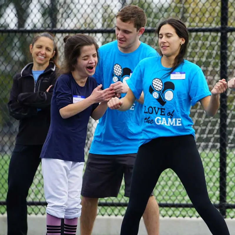 A child smiles while learning dance moves at Love of the Game, a student-run community outreach program that held a floor hockey clinic for people with developmental disabilities.