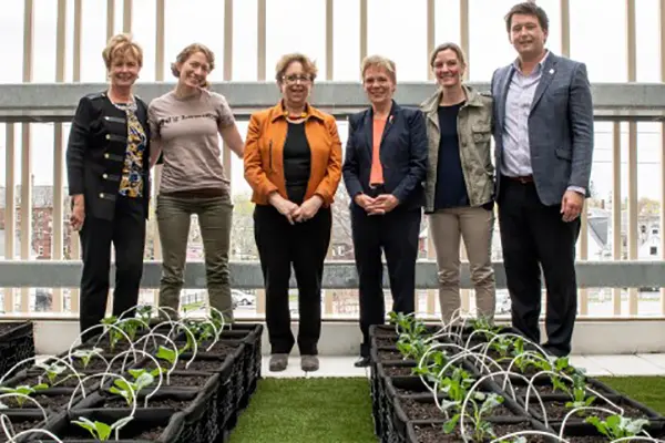 UML staff members standing in front of rooftop garden