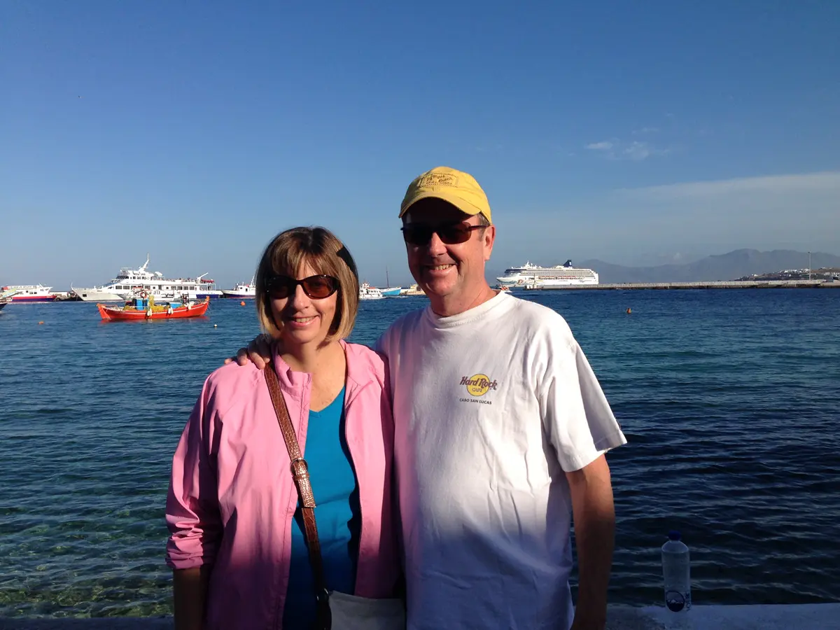 UMass Lowell alumni Frank Talty with his wife Patty Talty, pictured in front of the ocean in the summer with sunglasses on