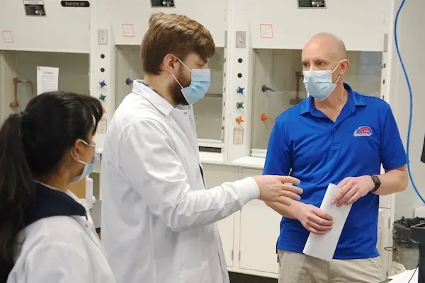 Lab director Matthew Gage talks to student workers