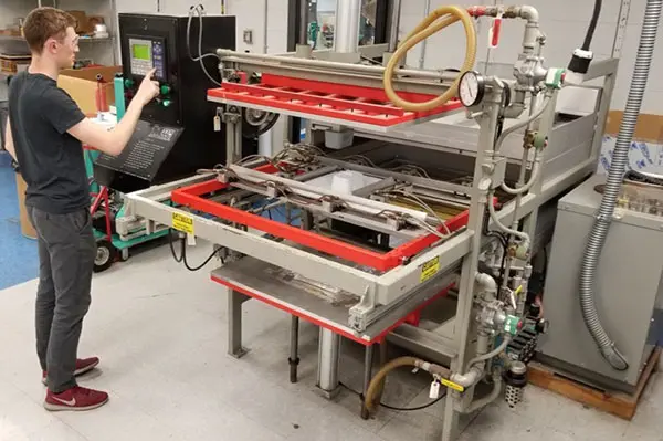 Technician operates Maac Thermoforming Machinery