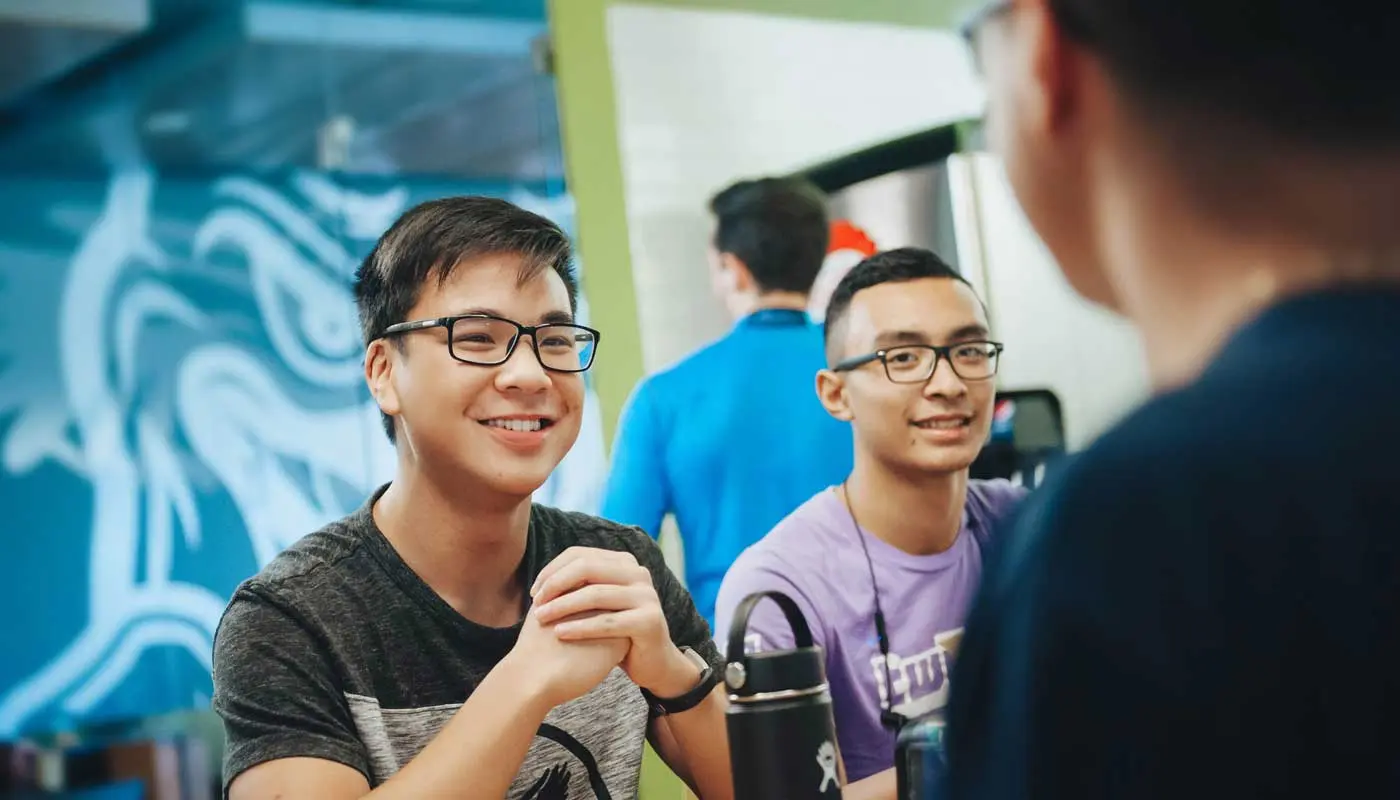 Three students seated at a table