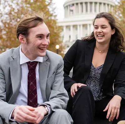 Two students seated outdoors