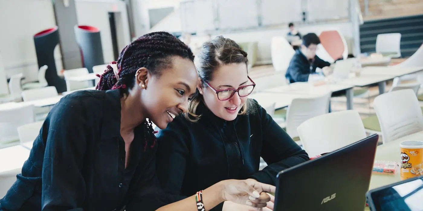 2 women leaning over computer 1600